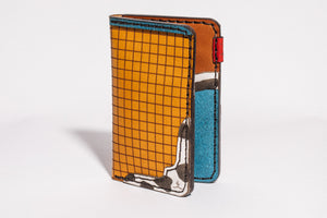 exterior/interior view of multicolor four pocket vertical wallet with red, blue, yellow, and cowprint leather