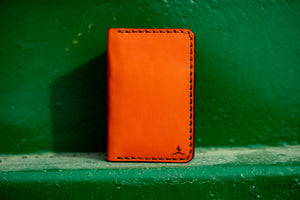 front view four pocket vertical orange leather wallet 