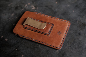 two pocket simple brown leather wallet with brass money clip on exterior back