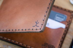 corner detail of Whiskey cordovan and brown leather six pocket bifold wallet
