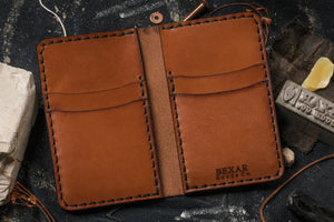 interior view of brown leather four pocket vertical wallet with brass money clip on exterior