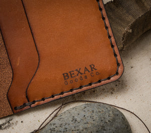 closeup view of Bexar laser engraved pocket of brown leather four pocket folding wallet with brass money clip