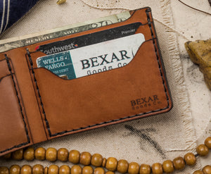interior view of 4 pocket brown bifold wallet showing cards and cash