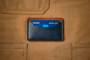 blue and brown leather two pocket slim wallet with cards inserted