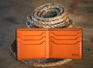 interior view of Orange six pocket bifold wallet next to twine rope