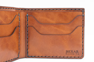 interior closeup of blue cordovan and brown leather four pocket bifold wallet