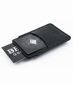 top view of black leather card sleeve with outer sleeve wallet with cards exiting pockets
