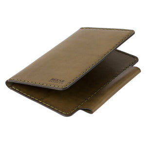 closed profile view of green and brown leather notebook wallet with two card pockets