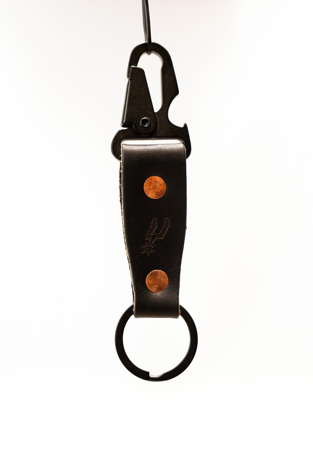 Black leather keychain with metal clip and copper accents on a white background