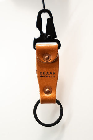 Leather key fob with black carabiner on a white background