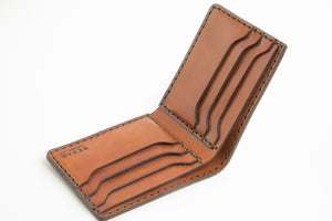top interior view of green exterior and brown interior leather six pocket bifold wallet