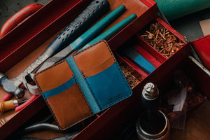 blue exterior and brown interior leather wallet with four card pockets inside toolbox with leathercrafting tools