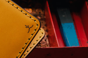closeup view of cactus engraved in corner of yellow wallet