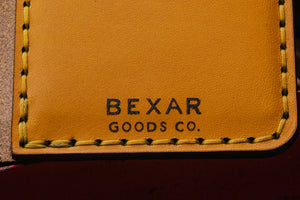 closeup of laser engraved Bexar logo on yellow vertical wallet