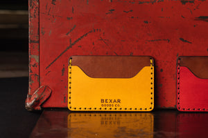 Yellow and brown slim wallet- two pocket with one center divider next to metal tool box