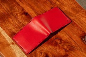 red  leather six pocket wallets shown open exterior on wood block