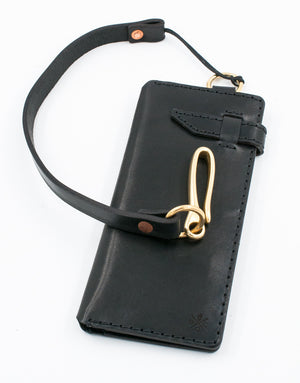 closed view of black leather eight pocket long wallet with two cash storage sleeves and brass lanyard