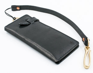 side view of black leather eight pocket long wallet with two cash storage sleeves and brass lanyard