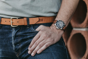 Adult male closeup of leather watch strap and tan leather belt