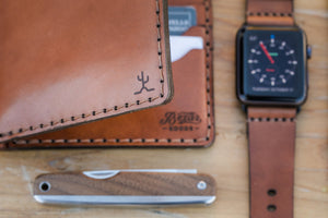 detail of cactus engraving of Whiskey cordovan and brown leather six pocket bifold wallet