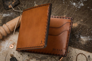 closeup view of cactus and Bexar engraved into brown leather 4 pocket wallet
