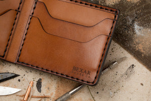 detailed look of four pocket bifold wallet showing Bexar Goods Co. engraving on bottom right corner