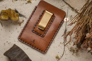 portrait shot of two pocket simple brown leather wallet with brass money clip on exterior back