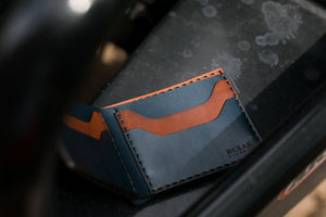 open interior view of blue and brown leather four card pocket bifold wallet