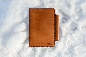 exterior view of leather notebook wallet on snow