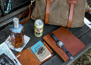 overview of leather accessories and  brown leather notebook wallet with card sleeves and passport sleeve