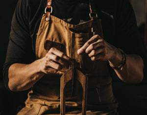 man handstitching wallet