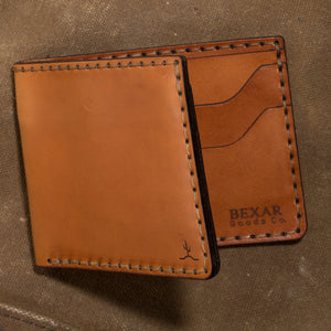 profile view of whiskey cordovan leather with brown interior four pocket bifold wallet