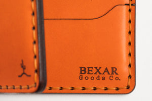 interior view of laser engraved Bexar branding on interior of Orange six pocket bifold wallet