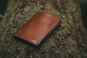 closed view of brown leather passport wallet with two card pockets and internal sleeve
