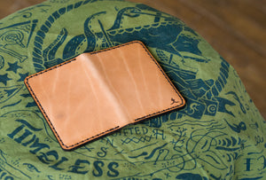 open exterior view of russet colored brown vertical wallet with four card pockets