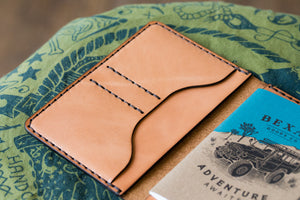 open interior view of russet brown color leather wallet with 4x4 vehicle notebook and two card pockets