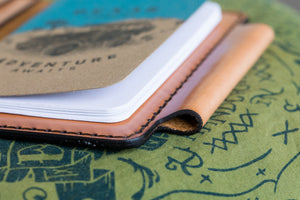 detail image of pen slot of russet brown color leather wallet with 4x4 vehicle notebook and two card pockets