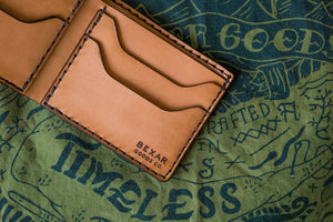detail view of pocket showing laser engraved Bexar logo on russet brown color leather wallet with four card pockets