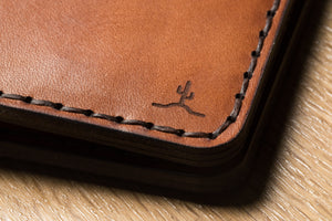 cactus engraving on corner of brown leather wallet