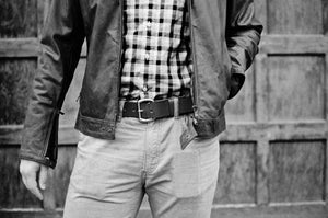 Adult male wearing leather jacket with a matching medium brown leather belt