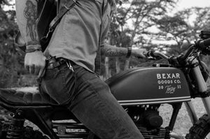 man on motorcycle with black leather eight pocket long wallet with two cash storage sleeves and brass lanyard in back pocket