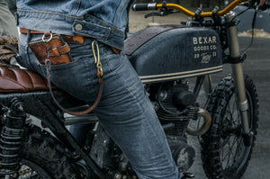 man on motorcycle with eight pocket long brown leather wallet with brass keychain lanyard in rear pocket