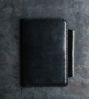 folded view of black leather notebook wallet with two card pockets and pen sleeve