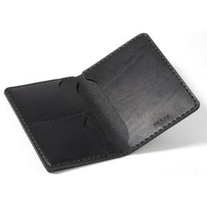 open interior view of black leather passport wallet with two card pockets